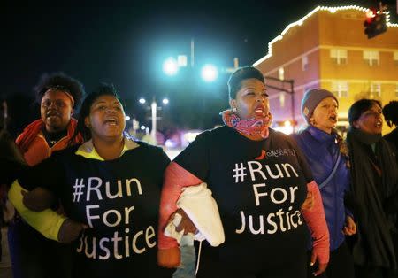 Protesters march in Ferguson, Missouri, October 11, 2014. REUTERS/Jim Young