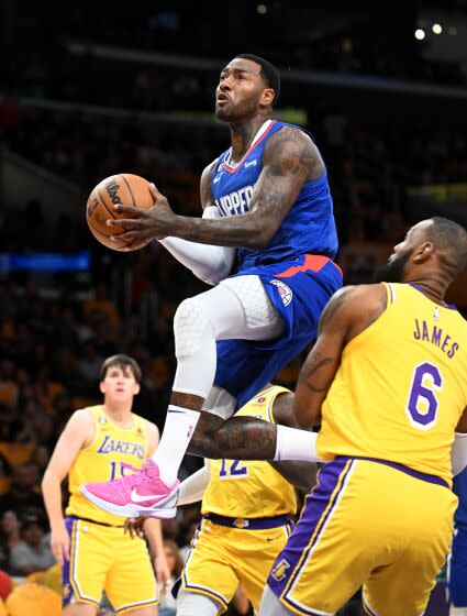 Clippers guard John Wall drives through the Lakers defense to score a basket in the second quarter Thursday.