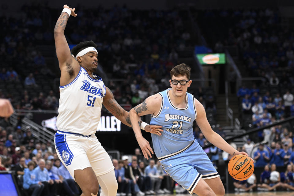 Drake's Darnell Brodie (51), left, defends against Indiana State's Robbie Avila during the first half of the championship game in the Missouri Valley Conference NCAA basketball tournament Sunday, March 10, 2024, in St. Louis. (AP Photo/Joe Puetz)