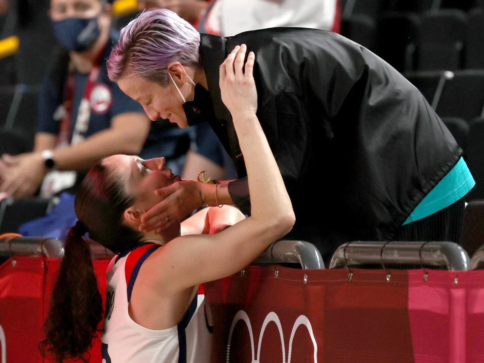 Megan Rapinoe kisses Sue Bird following the latter's gold-medal win in Tokyo.