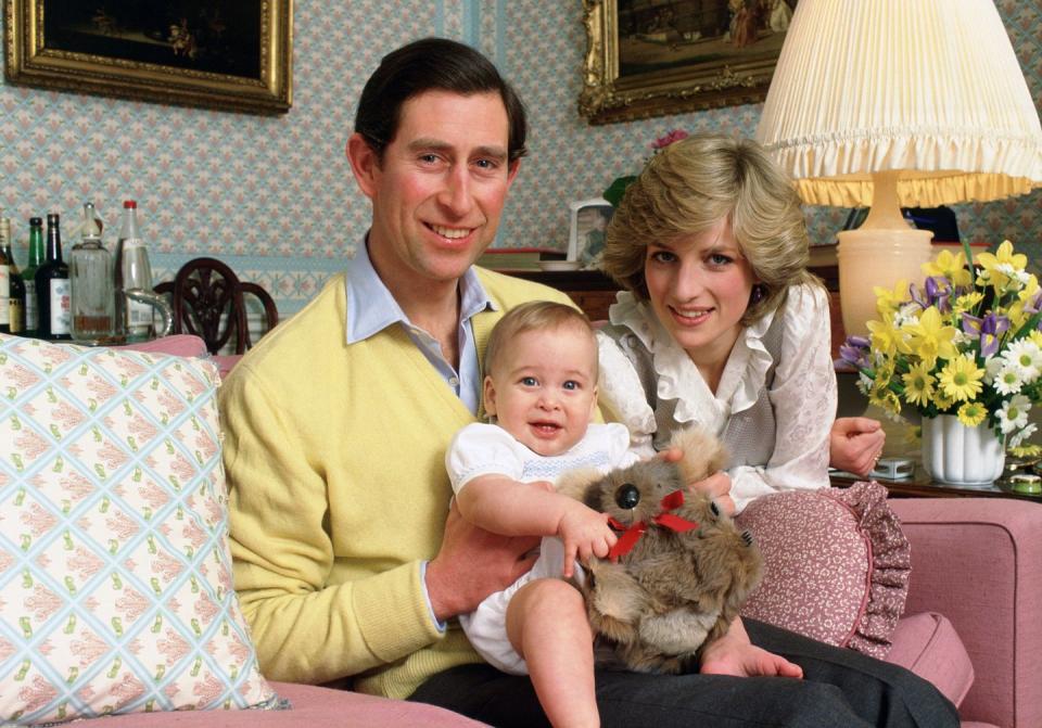 <p>The Prince And Princess of Wales hold baby Prince William at Kensington Palace. </p>