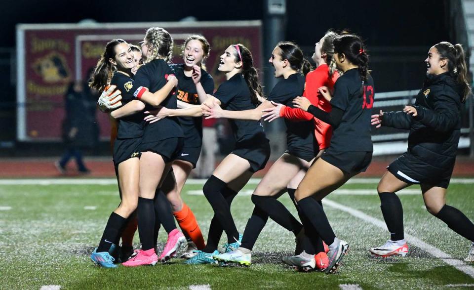 Oakdale players mob Mia Peterson, left, as they celebrate their victory over Manteca in the Sac-Joaquin Section Division III semifinal game with Manteca in Oakdale, Calif., Friday, Feb. 16, 2024.