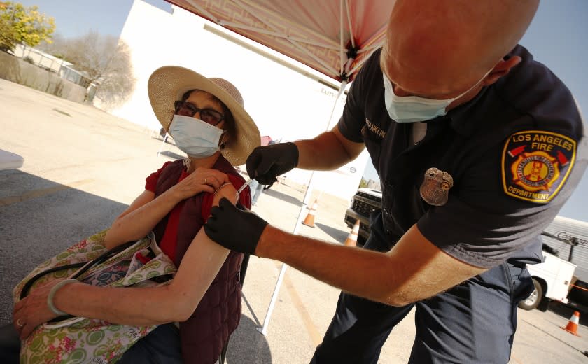 LOS ANGELES, CA - FEBRUARY 24: Yuyao Lui, 76, receives the Pfizer COVID-19 vaccine from LA City Firefighter Paramedic Joseph Franklin as the LA City CORE mobile team is staging a COVID-19 vaccination clinic in Chinatown for senior citizens, in an attempt to improve access to the vaccine among vulnerable populations. Chinatown on Wednesday, Feb. 24, 2021 in Los Angeles, CA. (Al Seib / Los Angeles Times).