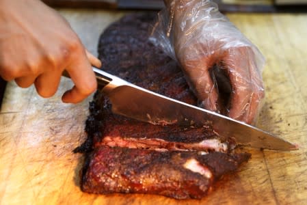 A chef cuts U.S. imported pork ribs that were smoked at the Beijing barbeque restaurant Home Plate that specializes in meat from the U.S.