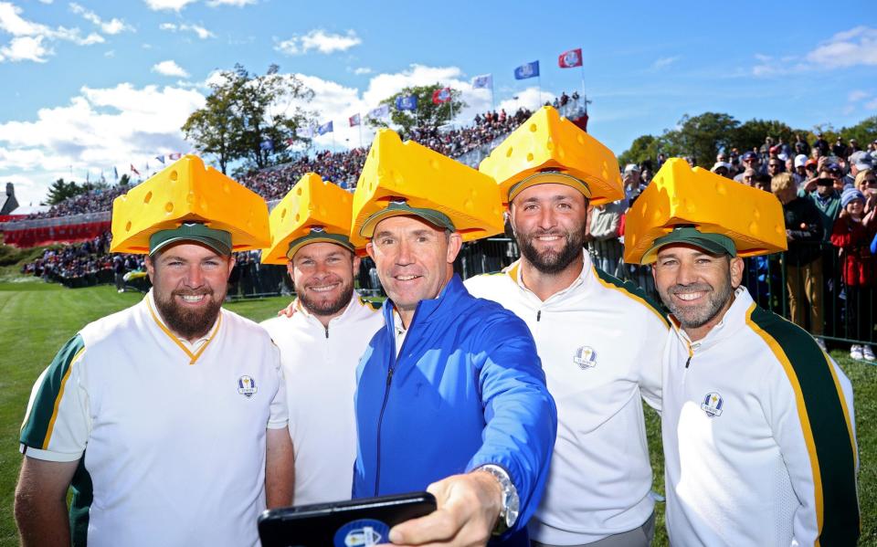 Shane Lowry, Tyrrell Hatton, Padraig Harrington, Jon Rahm and Sergio Garcia pose while wearing cheese head hats - GETTY IMAGES