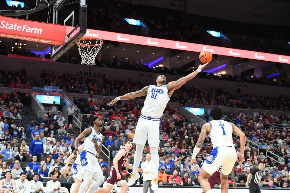 Darnell Brodie (51) tips a rebound to teammate Roman Penn (1) during a semifinal matchup between Drake men's basketball and Southern Illinois.