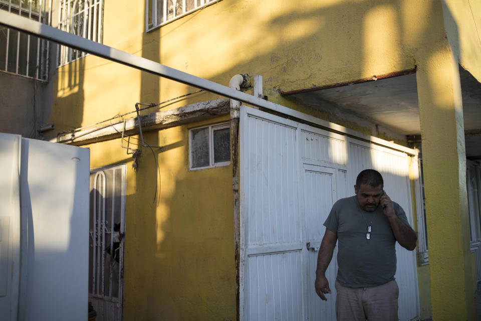 Alex Varela talks on his phone on Nov. 28, 2018, after taking a woman and her three children to his relative’s home in Juarez,. (Photo: Adria Malcolm for Yahoo News)
