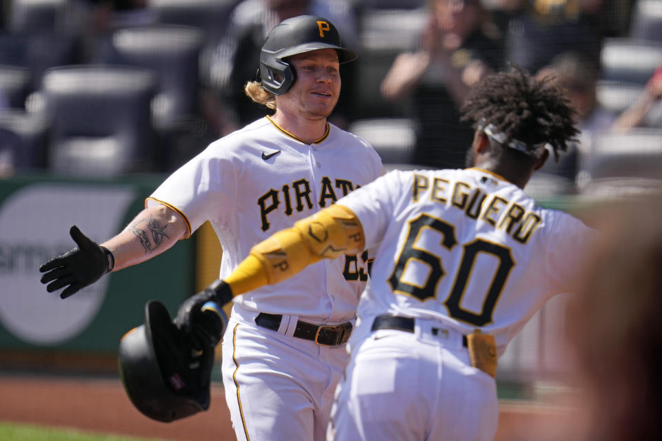 Pittsburgh Pirates' Jack Suwinski, left, returns to the dugout after hitting a solo home run off Washington Nationals starting pitcher Josiah Gray during the second inning of a baseball game in Pittsburgh, Thursday, Sept. 14, 2023. (AP Photo/Gene J. Puskar)