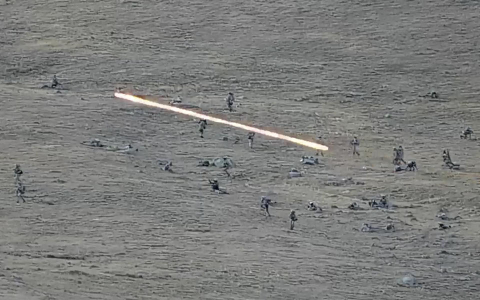 In this image taken from a YouTube footage released by Armenian Defense Ministry on Tuesday, Sept. 13, 2022, shows Azerbaijanian servicemen crossing the Armenian-Azerbaijani border and approaching the Armenian positions. Armenia's prime minister says that 49 soldiers have been killed in nighttime attacks by Azerbaijan. (Armenian Defense Ministry via AP)