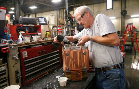 Assembly product worker Ron Leenheer works on the final assembly of a water cooled transformer at RoMan Manufacturing in Grand Rapids, Michigan, U.S. December 12, 2018. Picture taken December 12, 2018. REUTERS/Rebecca Cook