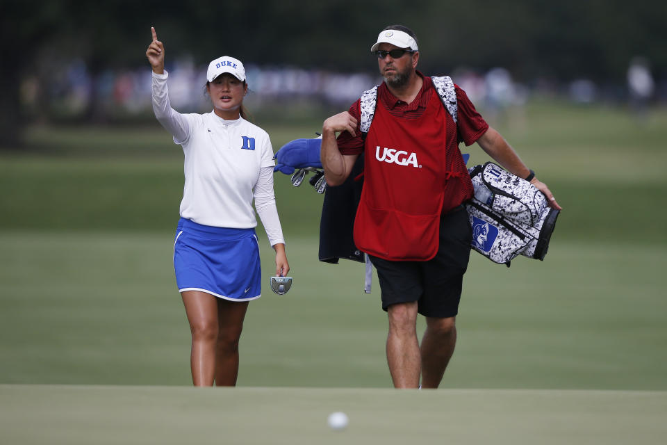 Gina Kim speaks with caddie Ben Sorrels on their way to the fourth green during the second round of the U.S. Women's Open golf tournament, Friday, May 31, 2019, in Charleston, S.C. (AP Photo/Mic Smith)