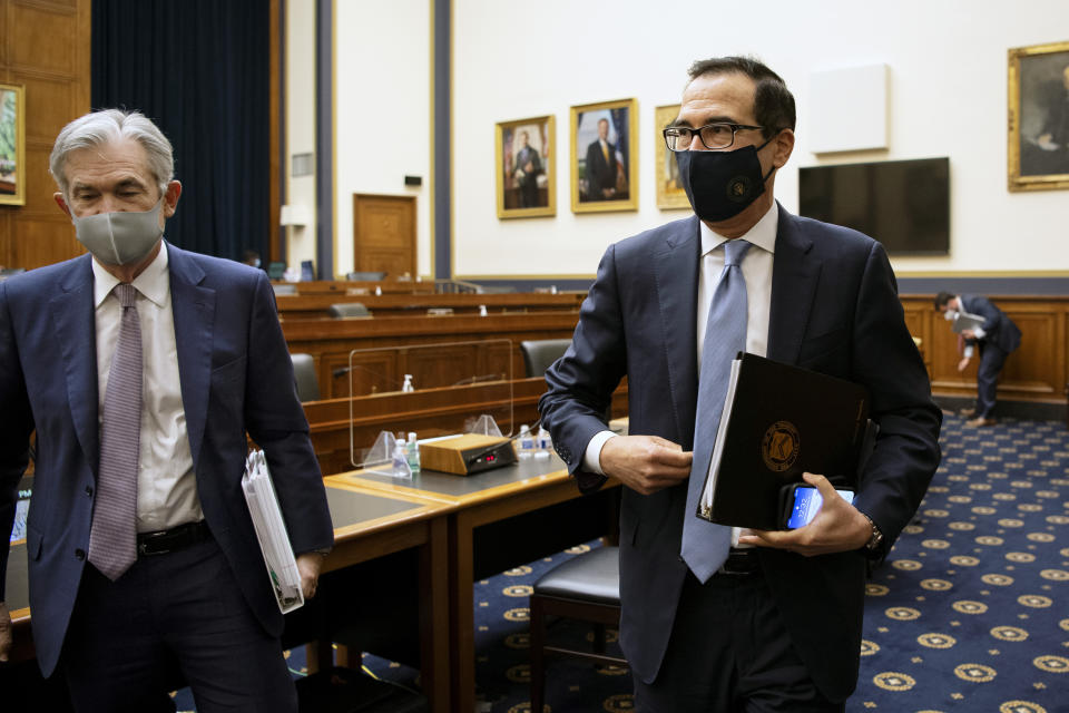 Federal Reserve Chair Jerome Powell, left, and Treasury Secretary Steve Mnuchin leave after a House Financial Services Committee hearing about the government’s emergency aid to the economy in response to the coronavirus on Capitol Hill in Washington on Tuesday, Sept. 22, 2020. (Caroline Brehman/Pool via AP)