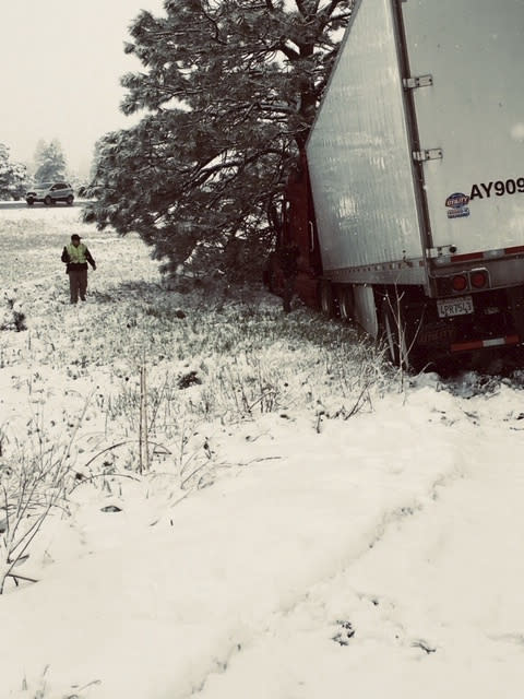 This photo provided by the Ponderosa Fire District shows a multiple car accident caused by slick roads from a snow fall near Flagstaff, Ariz. on Thursday, May 23, 2019. Northern Arizona is getting a rare dose of late-season snow. The National Weather Service is recording snow in the inches near Flagstaff, in Seligman and at the Grand Canyon's South Rim. (Erin Hudman/Ponderosa Fire District via AP)