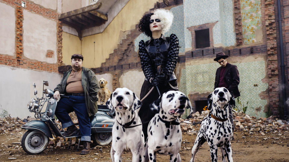 This image released by Disney shows Paul Walter Hauser, from left, Emma Stone and Joel Fry in a scene from "Cruella." (Disney via AP)