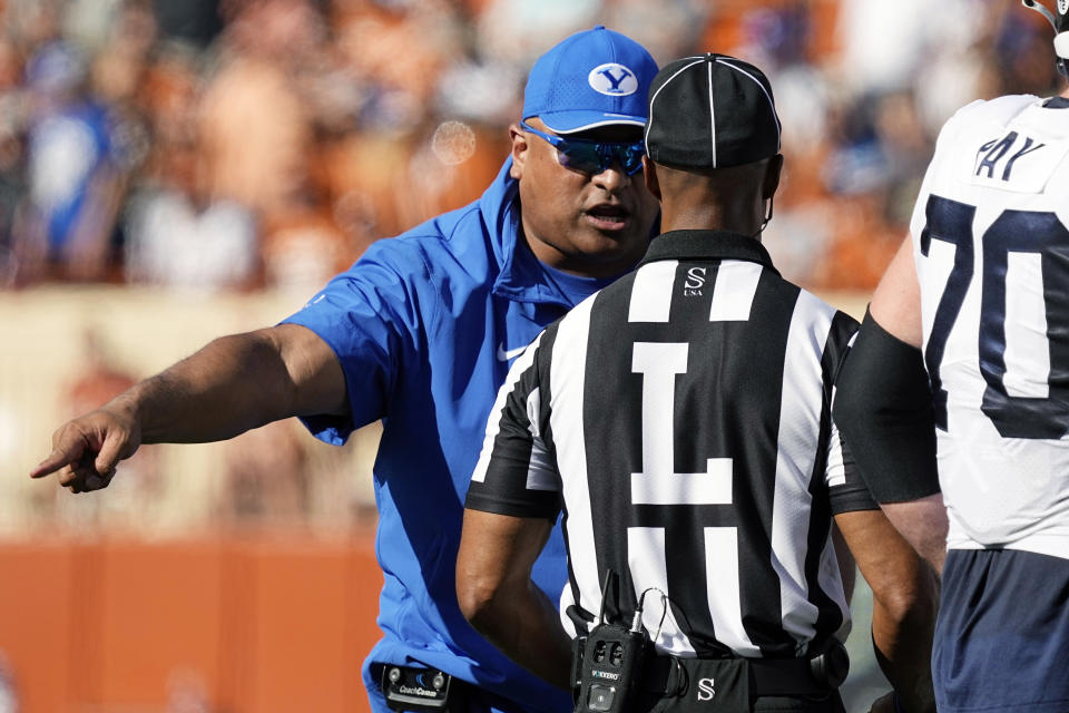 BYU head coach Kalani Sitake, left, argues a call during the first half of an NCAA college football game against Texas in Austin, Texas, Saturday, Oct. 28, 2023. (AP Photo/Eric Gay)