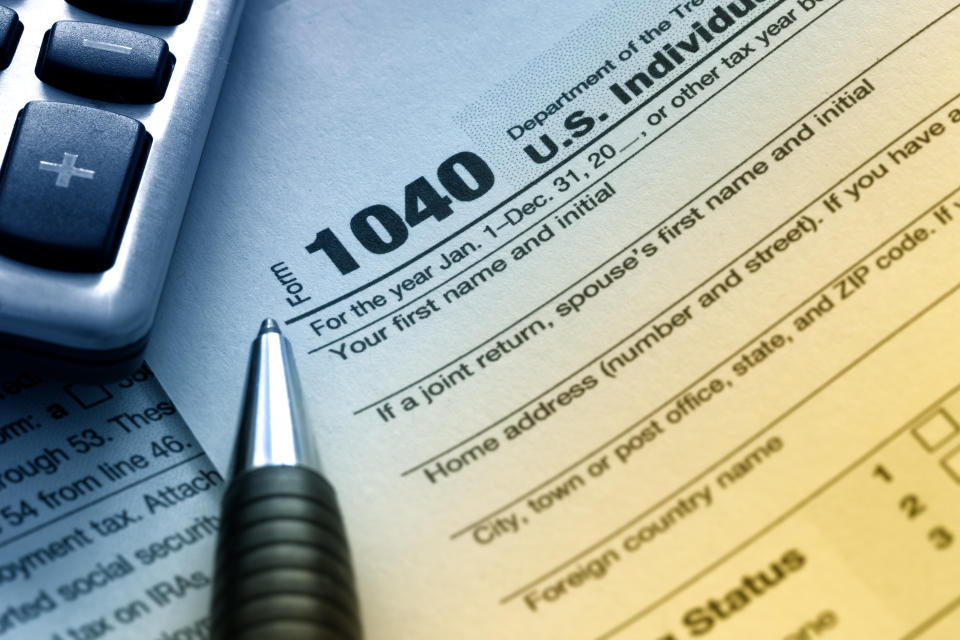 US tax form 1040 with pen and calculator.