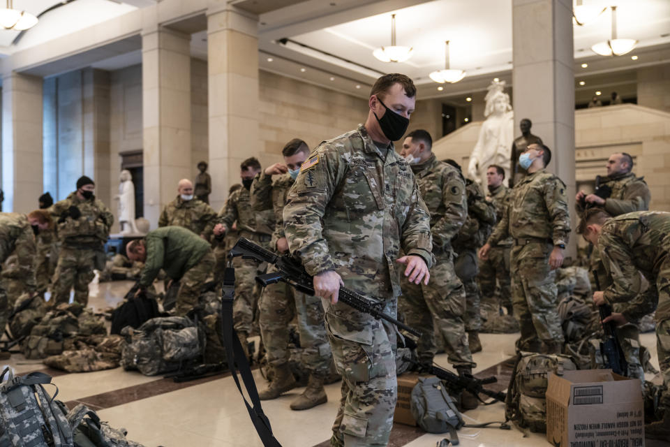 Hundreds of National Guard troops hold inside the Capitol Visitor's Center to reinforce security at the Capitol in Washington, Wednesday, Jan. 13, 2021. The House of Representatives is pursuing an article of impeachment against President Donald Trump for his role in inciting an angry mob to storm the Capitol last week. (AP Photo/J. Scott Applewhite)