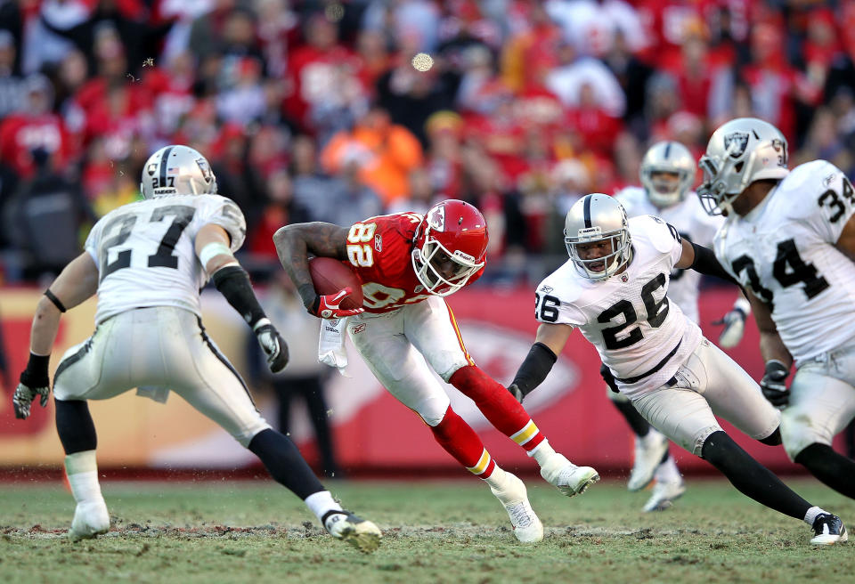 Receiver Dwayne Bowe #82 of Kansas City Chiefs carries the ball after making a catch as Matt Giordano #27 of the Oakland Raiders defends during the game on December 24, 2011 at Arrowhead Stadium in Kansas City, Missouri. (Photo by Jamie Squire/Getty Images)