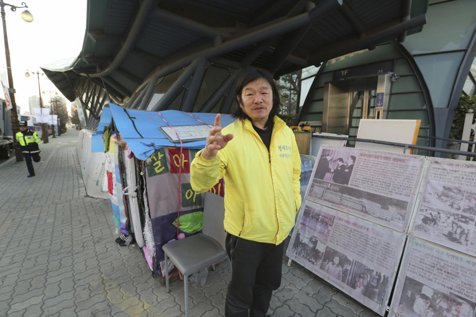 In this April 2, 2019, photo, Choi Seung-woo, a victim of Brothers Home, speaks during an interview in front of National Assembly in Seoul, South Korea. Choi and a small number of other Brothers Home inmates have been camping out in front of the National Assembly’s gate for more than two years calling for lawmakers to pass a bill that would launch a full investigation into past human rights atrocities, including the Brothers Home incident. Notorious South Korean facility that kidnapped, abused and enslaved children and the disabled for a generation was also shipping children overseas for adoption as part of a massive profit-seeking enterprise. (AP Photo/Ahn Young-joon)