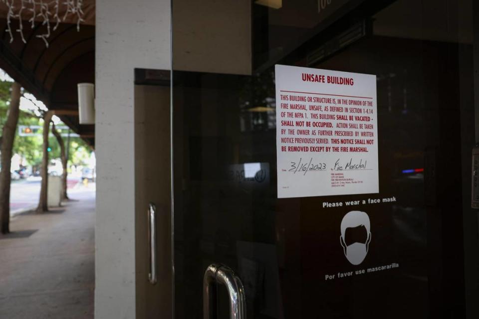 An unsafe building notice is posted on the front of the Huntington Building in downtown Miami on Thursday, March 23, 2023, a week after the building was shut down by the city for safety issues.