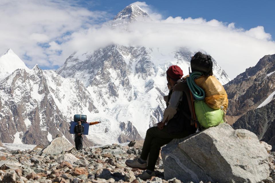 This picture taken on July 15, 2023, shows a Pakistani porter looking towards K2, world's second tallest mountain in the Karakoram range of GilgitBaltistan, Pakistan.