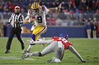 FILE - In this Nov. 16, 2019, file photo, LSU quarterback Joe Burrow (9) avoids Mississippi linebacker Jacquez Jones (10) during the first half of an NCAA college football game, in Oxford, Miss. LSU quarterback Joe Burrow is The Associated Press college football player of the year in a landslide vote. Burrow, who has led the top-ranked Tigers to an unbeaten season and their first College Football Playoff appearance, received 50 of 53 first-place votes from AP Top 25 poll voters and a total of 156 points. (AP Photo/Thomas Graning, File)