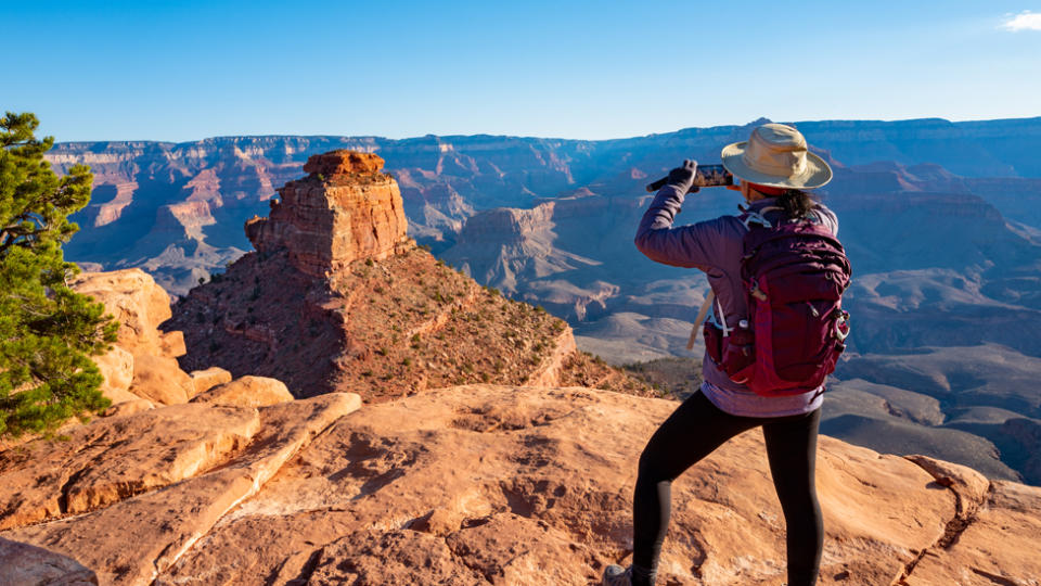A woman admires the South Rim of the Grand Canyon.