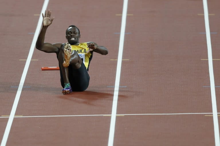 Jamaica's Usain Bolt goes down after pulling up injured in the final of the men's 4x100m relay athletics event at the 2017 IAAF World Championships at the London Stadium in London on August 12, 2017