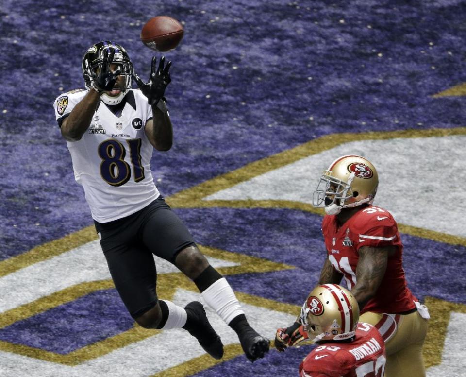 Baltimore Ravens wide receiver Anquan Boldin (81) catches a 13-yard pass for a touchdown as San Francisco 49ers safety Donte Whitner (31) and teammate NaVorro Bowman (53) trail the play during the first half of the NFL Super Bowl XLVII football game, Sunday, Feb. 3, 2013, in New Orleans. (AP Photo/Charlie Riedel)