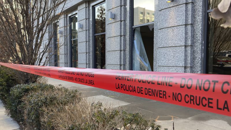 Police tape blocks the damage to large windows at the Colorado Supreme Court on Tuesday, Jan. 2, 2024 in Denver. Authorities say a man inflicted “extensive damage” to the building housing.