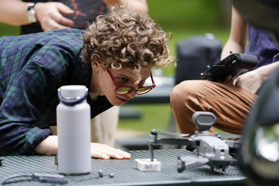 Robby Lewis-Nash, a staff writer with Friends with Casco Bay in Portland, Maine, inspects a participant’s drone during a training session Tuesday, June 7, 2022, in Poolesville, Md. People who work to protect rivers and waterways have begun using drones to catch polluters in places where wrongdoing is difficult to see or expensive to find. The images they capture have already been used as evidence to formally accuse companies of wrongdoing. (AP Photo/Julio Cortez)