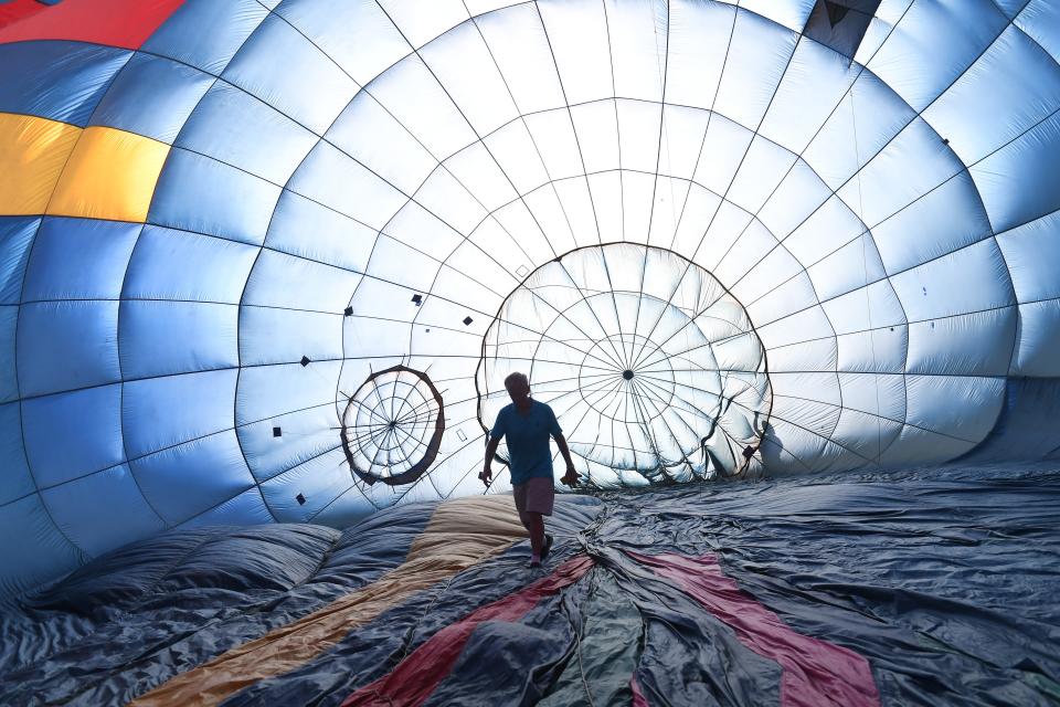 Hot Air Balloons filled the sky as Simpsonville hosted Balloon Fest at Historic Hopkins Farm. These are images on June 21. The event was at Hopkins Farm on June 21-22. Balloon pilot Steve Lambert checks out his equipment inside the balloon before flight.