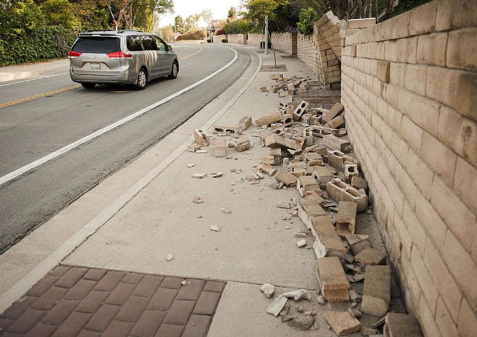 A broken block wall blocks the sidewalk Saturday, March 29, 2014, after an earthquake hit Orange County Friday night in Fullerton, Calif. More than 100 aftershocks have rattled Orange County south of Los Angeles where a magnitude-5.1 earthquake struck Friday. Despite the relatively minor damage, no injuries have been reported. (AP Photo/The Orange County Register, Ken Steinhardt) MAGS OUT; LOS ANGELES TIMES OUT