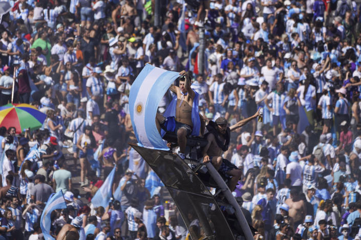 Argentine soccer fans celebrate their team's World Cup victory over France, in Buenos Aires, Argentina, Sunday, Dec. 18, 2022. (AP Photo/Matilde Campodonico)