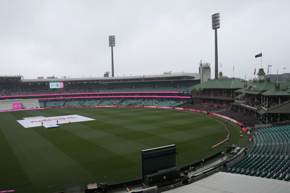 The covers are on the wicket as rain falls before play on the third day of the cricket test match between Australia and South Africa at the Sydney Cricket Ground in Sydney, Friday, Jan. 6, 2023. (AP Photo/Rick Rycroft)