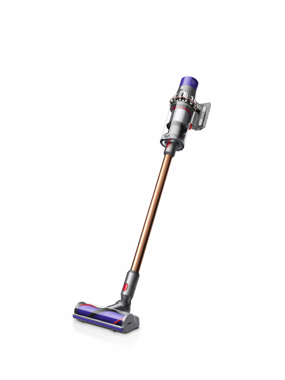 A dyson stick vacuum with gold stick and red, silver and purple trims stands on a white background.