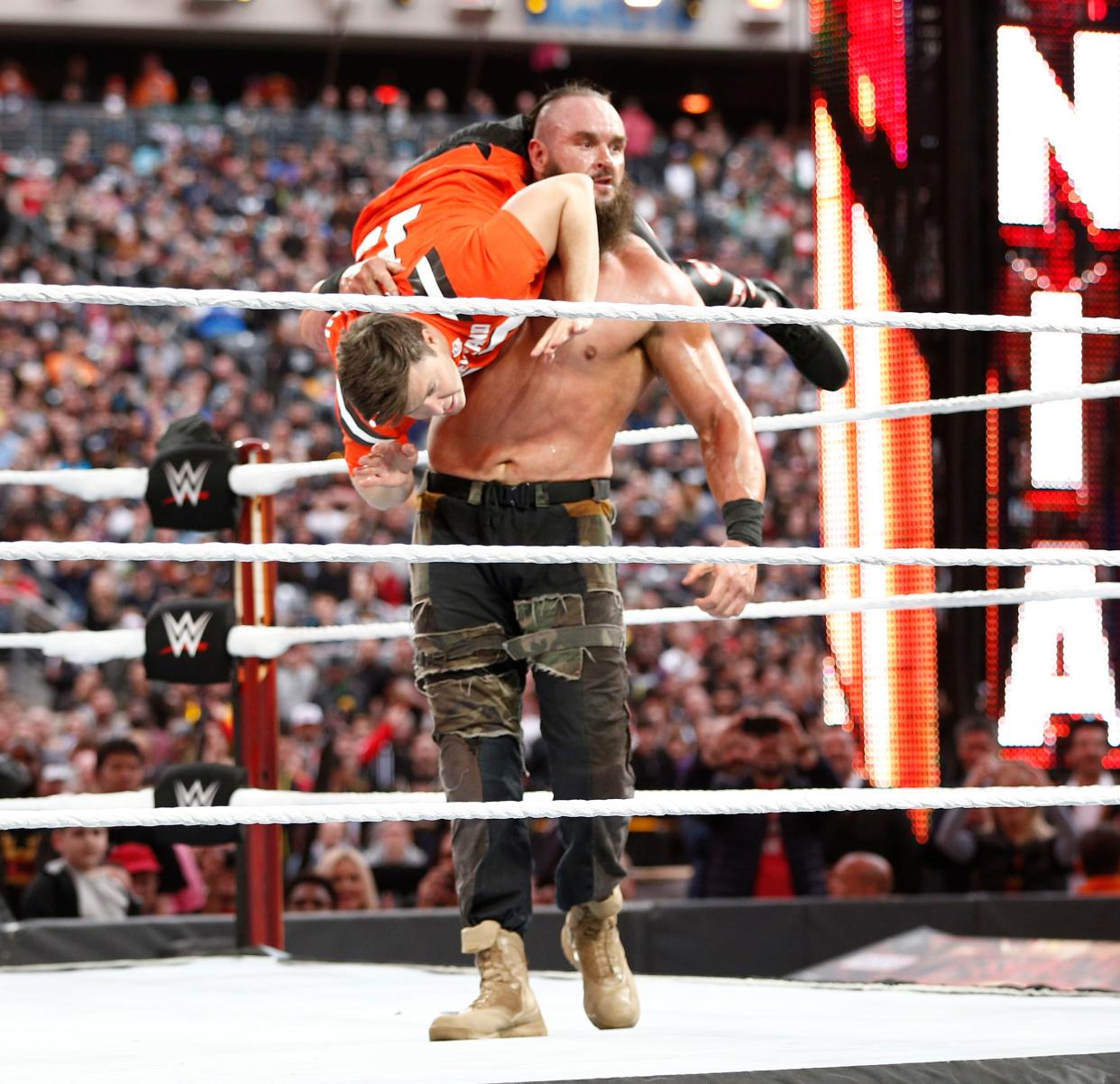 EAST RUTHERFORD, NEW JERSEY - APRIL 07: Colin Jost battles Braun Strowman in the ring during SNL's Michael Che and Colin Jost at WWE WrestleMania at Met Life Stadium on April 07, 2019 in East Rutherford, New Jersey. (Photo by Brian Ach/Getty Images for WWE)