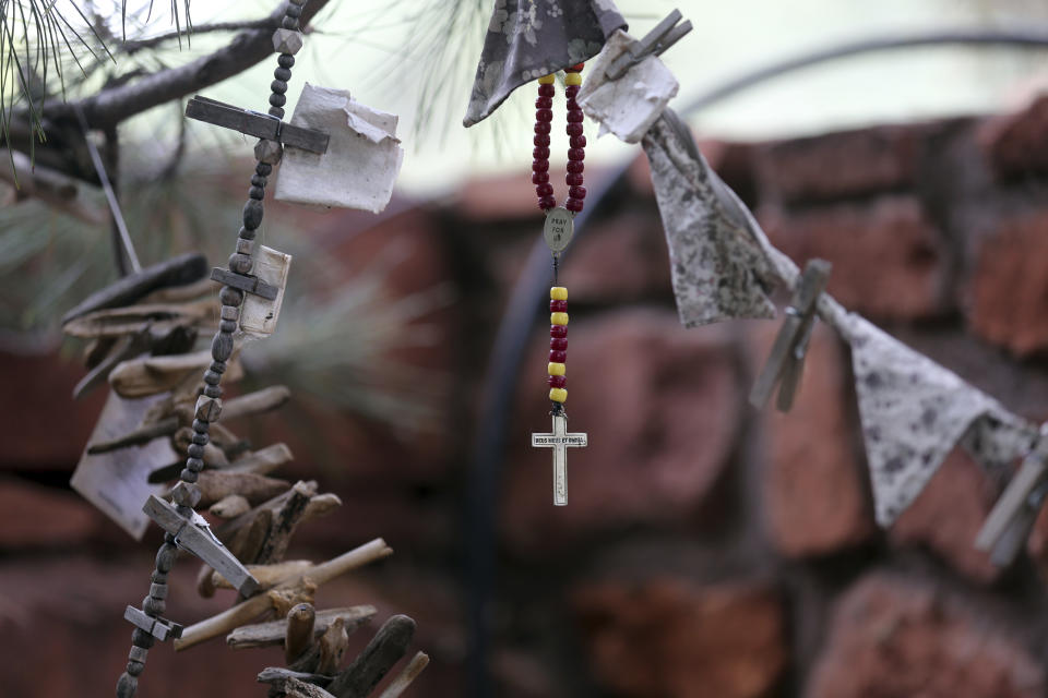 Mementos hang from a tree at the Selah Carefarm in Cornville, Ariz., Oct. 4, 2022. The farm is run by an Arizona State University professor, Joanne Cacciatore, whose baby daughter died during delivery in 1994, spurring a search for answers. She's focused her research on grief. (AP Photo/Dario Lopez-Mills)