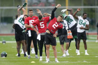 New York Jets' quarterback Zach Wilson (2), front, stretches with teammates at the NFL football team's training facility in Florham Park, N.J., Tuesday, May 24, 2022. (AP Photo/Seth Wenig)
