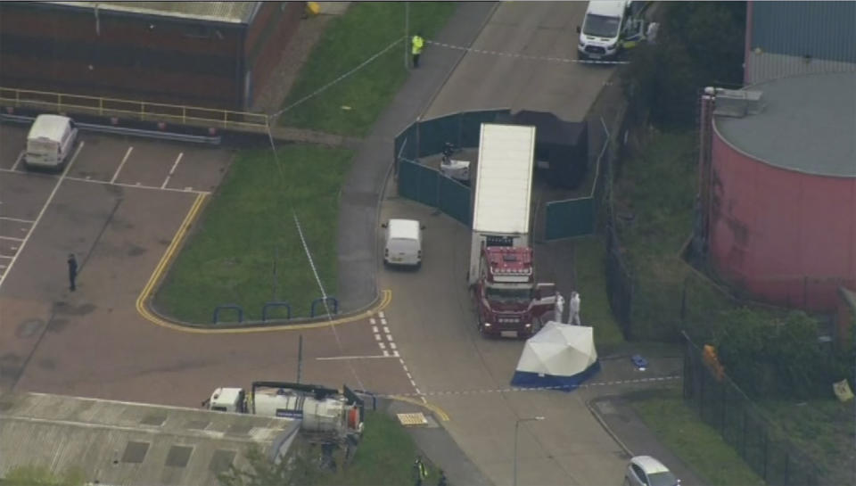 An aerial view as police forensic officers attend the scene after a truck was found to contain a large number of dead bodies, in Thurock, South England, early Wednesday Oct. 23, 2019. Police in southeastern England said that 39 people were found dead Wednesday inside a truck container believed to have come from Bulgaria. (UK Pool via AP)