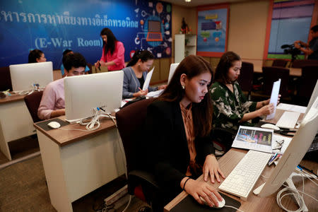 Government staff work as they monitor social media in a social media war room in Bangkok, Thailand March 8, 2019. Picture taken March 8, 2019. REUTERS/Soe Zeya Tun