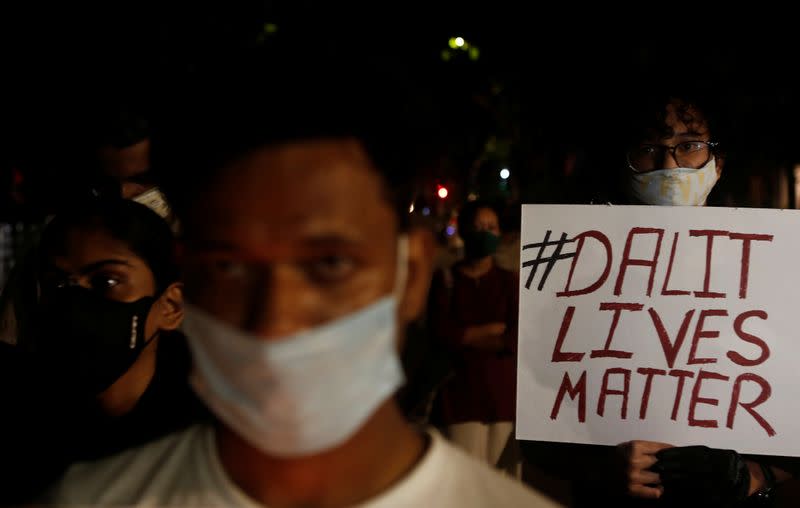 A man holds a placard during a protest after the death of a rape victim, on a street in Mumbai