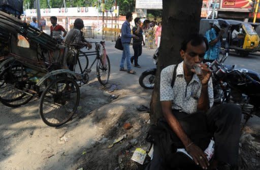 An Indian drinks tea at roadside shop in Siliguri on May 26. The Indian economy expanded by a much slower-than-expected 5.3 percent in the January-March quarter, official data showed, adding further pressure on the embattled government