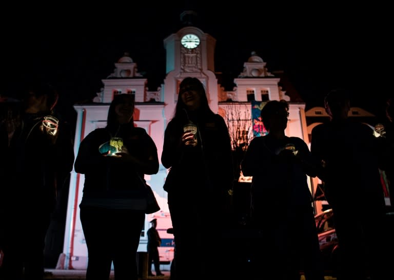 Residents hold a candle-light vigil in Ostritz' main square during a "Peace Festival" held to coincide with the Shield and Sword neo-nazi festival, in the eastern German town on April 20, 2018