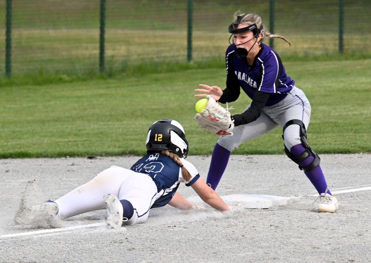 Willa Leighton of Monomoy dives back to third ahead of the tag by Bourne shortstop Jillian Allen during a May 24, 2023 game in Harwich.