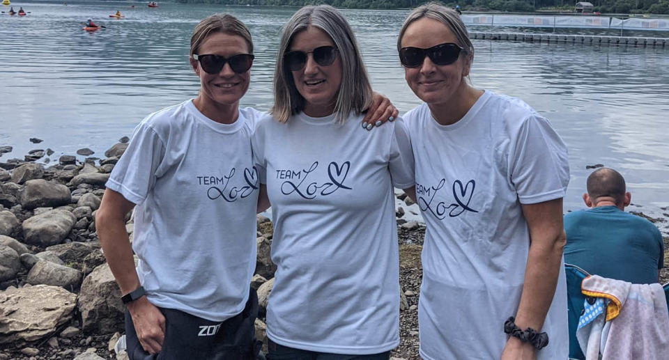 A photo of Sarah Menzies and two of her friends, dressed in shirts that say 