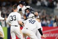 New York Yankees' Josh Donaldson celebrates with teammates Harrison Bader (22),, Anthony Rizzo (48) and Tim Locastro (33) after hitting a walk-off RBI single during the tenth inning of a baseball game against the Boston Red Sox Thursday, Sept. 22, 2022, in New York. The Yankees won 5-4. (AP Photo/Frank Franklin II)