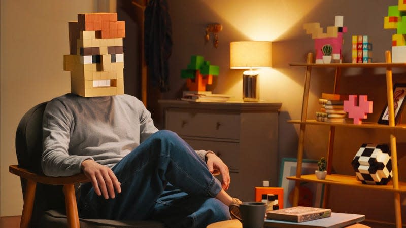 A person sitting in a chair wearing a pixelated mask built using the Voxart system.