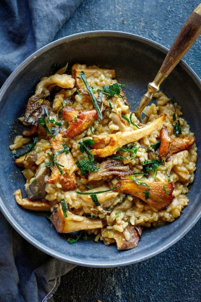 a bowl of mushroom risotto topped with leeks