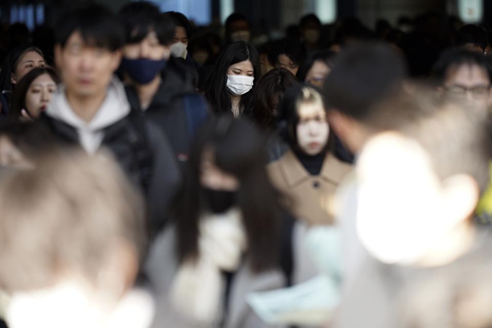 Commuters walk in a passageway during a rush hour at Shinagawa Station Wednesday, Feb. 14, 2024, in Tokyo. Japan has slipped to the world’s fourth-largest economy as government data released Thursday, Feb. 15, showed it fell behind the size of Germany's in 2023.(AP Photo/Eugene Hoshiko)